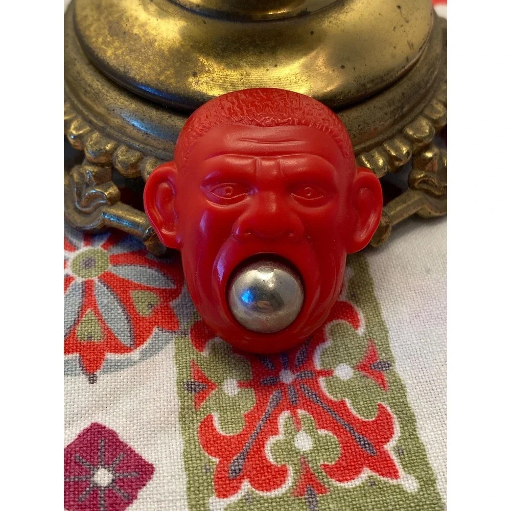 Vintage Red Plastic Monkey Head Novelty Toy with Removable Silver Ball Charm